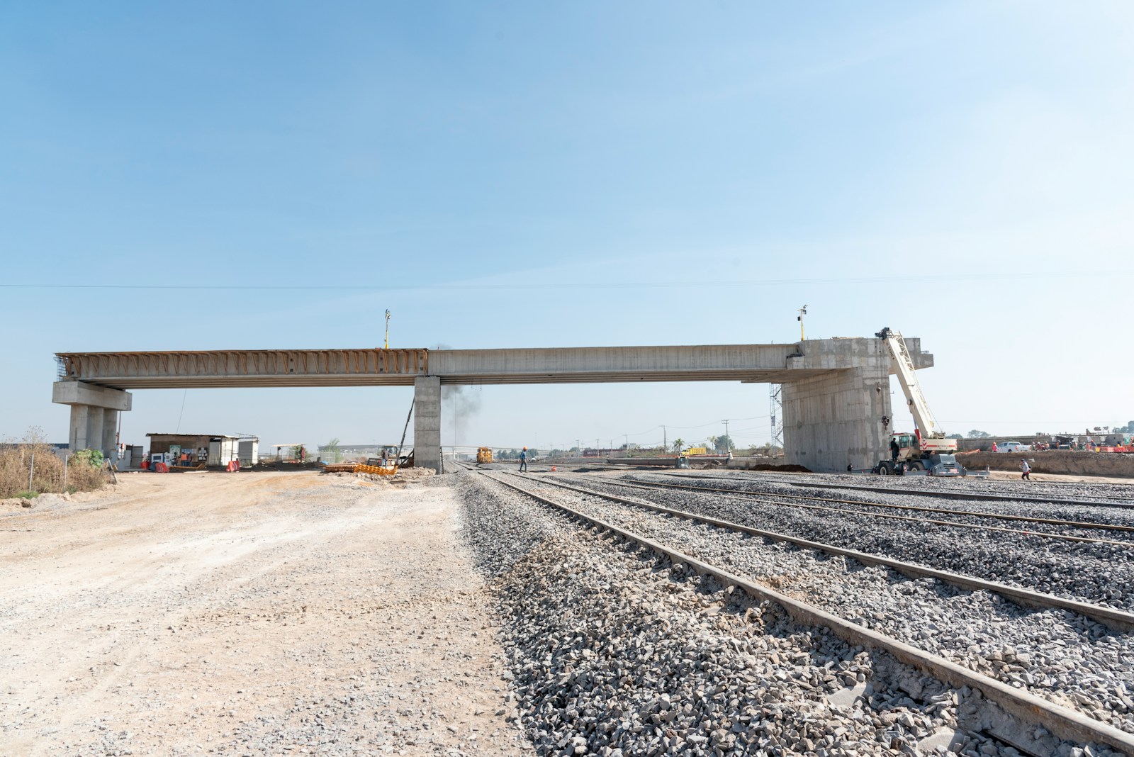 a train track with a bridge in the background